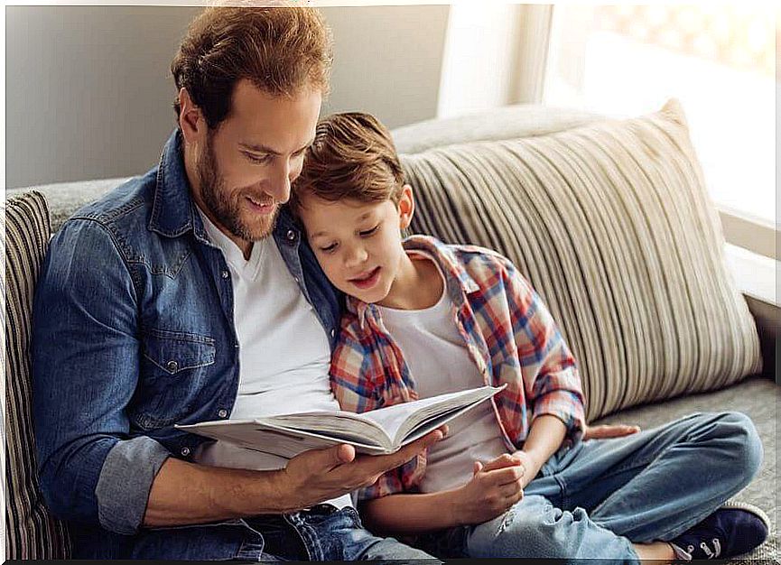 Father reading a book with his son