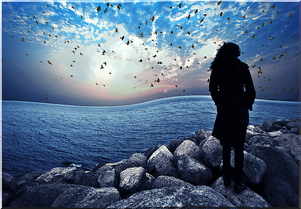 Woman with self-esteem problems looking at the sea