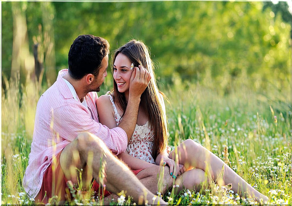 Boy putting a flower on his girlfriend's head