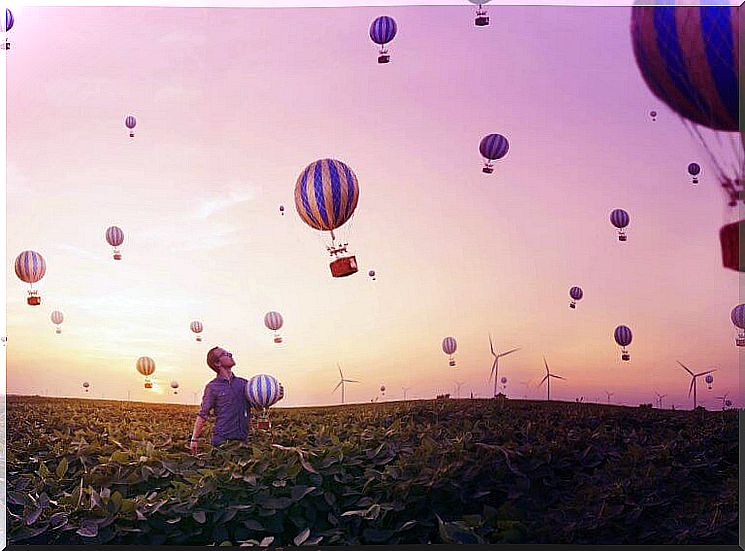 Man looking at balloons