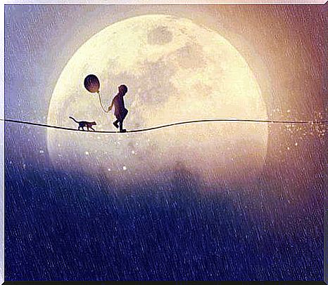 Boy walking with a cat near the moon