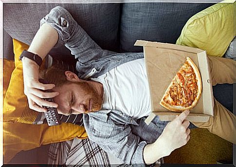 Bored man eating pizza