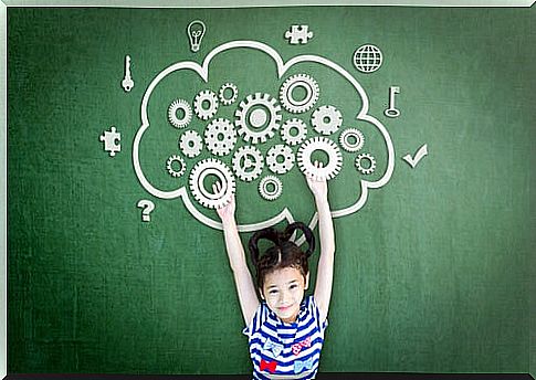 Little girl with brain drawn on blackboard