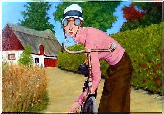 woman with pink sweater on her bicycle