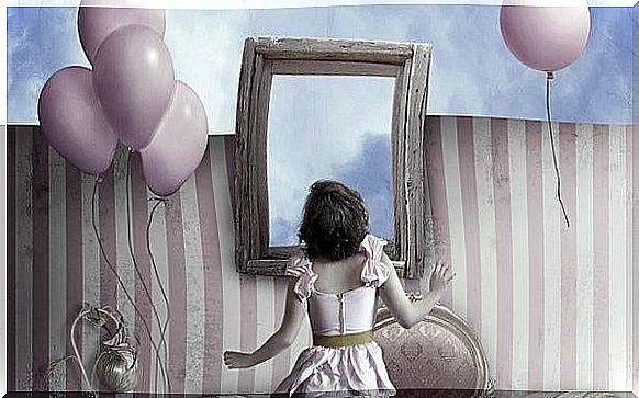 woman in front of a mirror surrounded by pink balloons