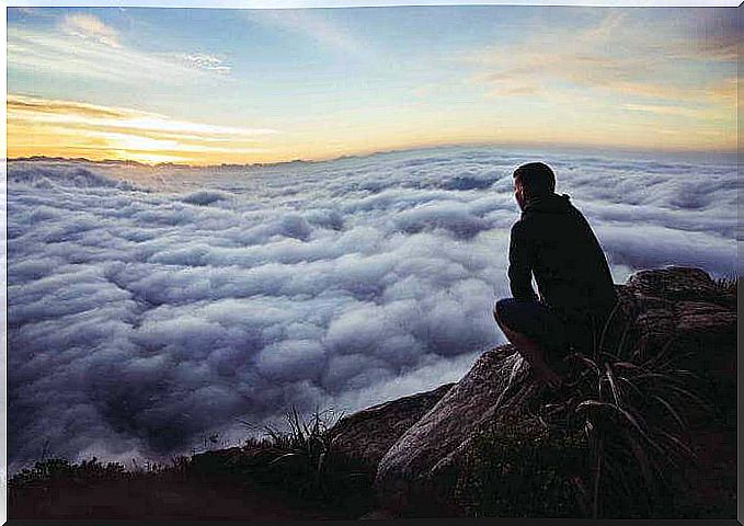 Man on the mountain thinking about putting distance