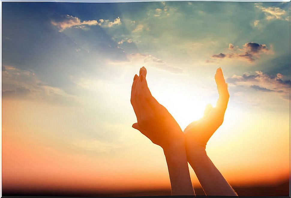 Hands surrounding the sun representing mindfulness phrases