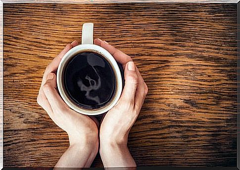 Hands of a woman with a cup of coffee