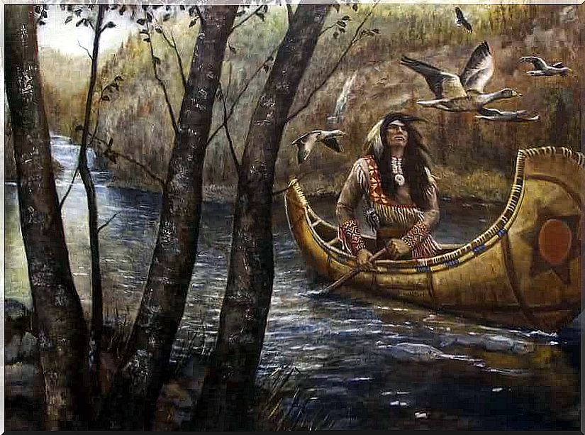 Indian navigating the river with a canoe