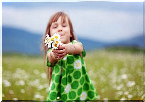 Girl with flowers in hands representing the representing the value of coexistence 