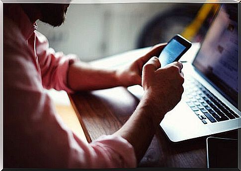 Man with a computer and a phone