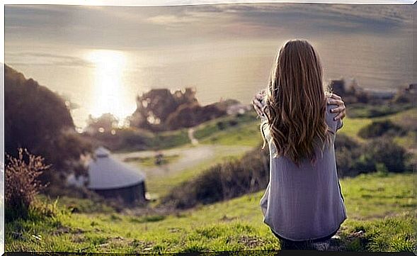 Girl from behind thinking about the paradox of happiness